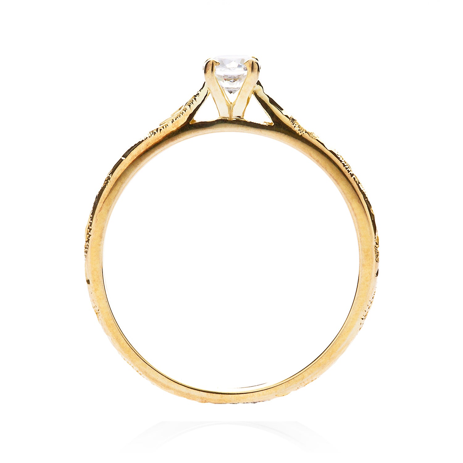 Solitaire engagement ring with a slim 18ct yellow gold band hand-engraved with intricate scrolls, and a 0.33ct round brilliant-cut diamond in a traditional four-claw setting, through view