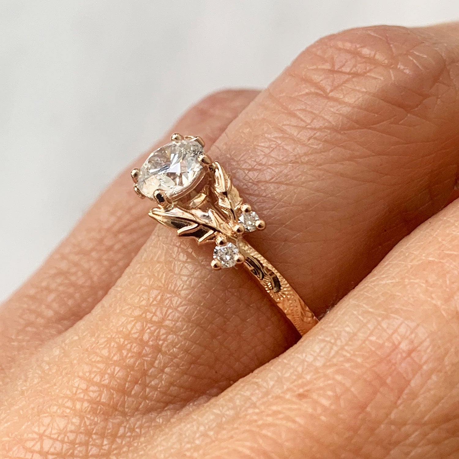 Bespoke rose Fairmined Gold and Canadmark conflict free diamond hand engraved solitaire engagement ring, on hand 2