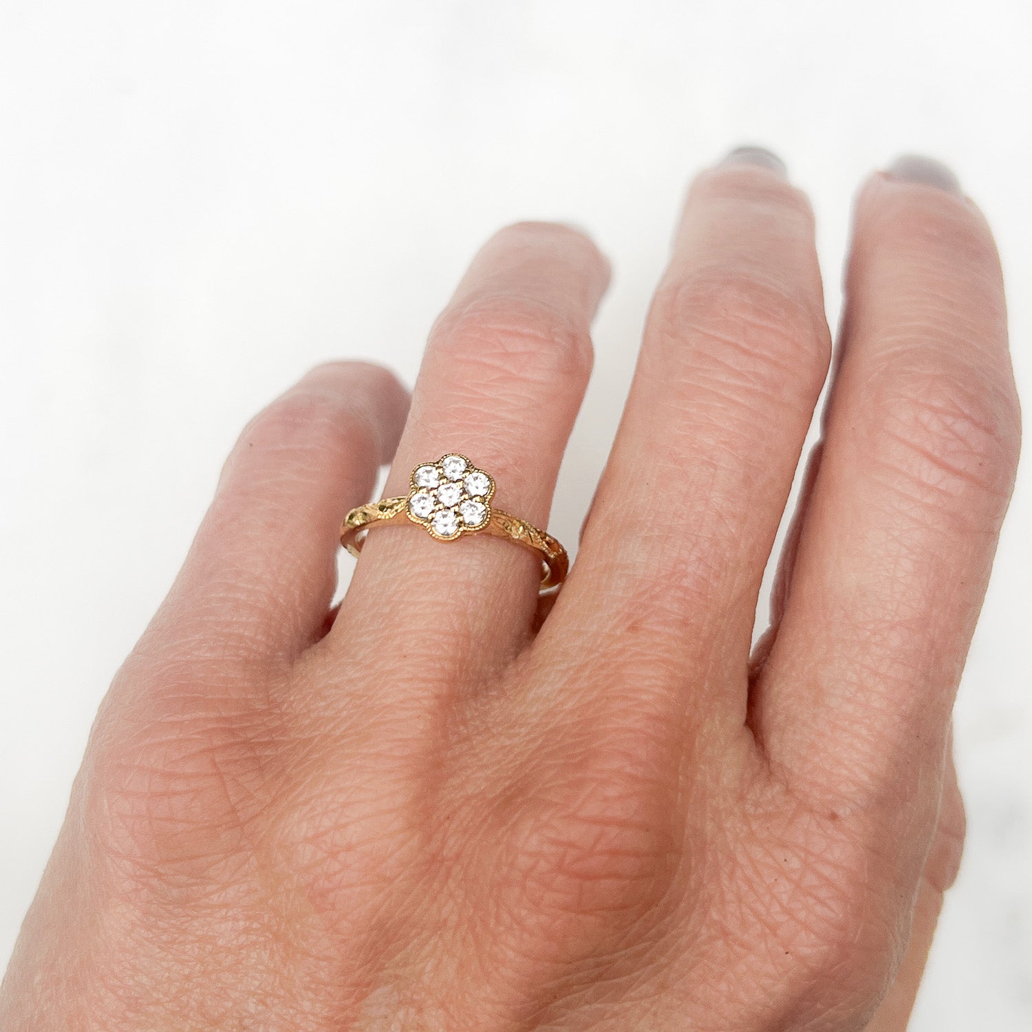 Daisy Ethical Diamond Cluster Engagement Ring, hand engraved, with traceable and conflict-free Canadian diamonds and 100% recycled yellow gold on hand