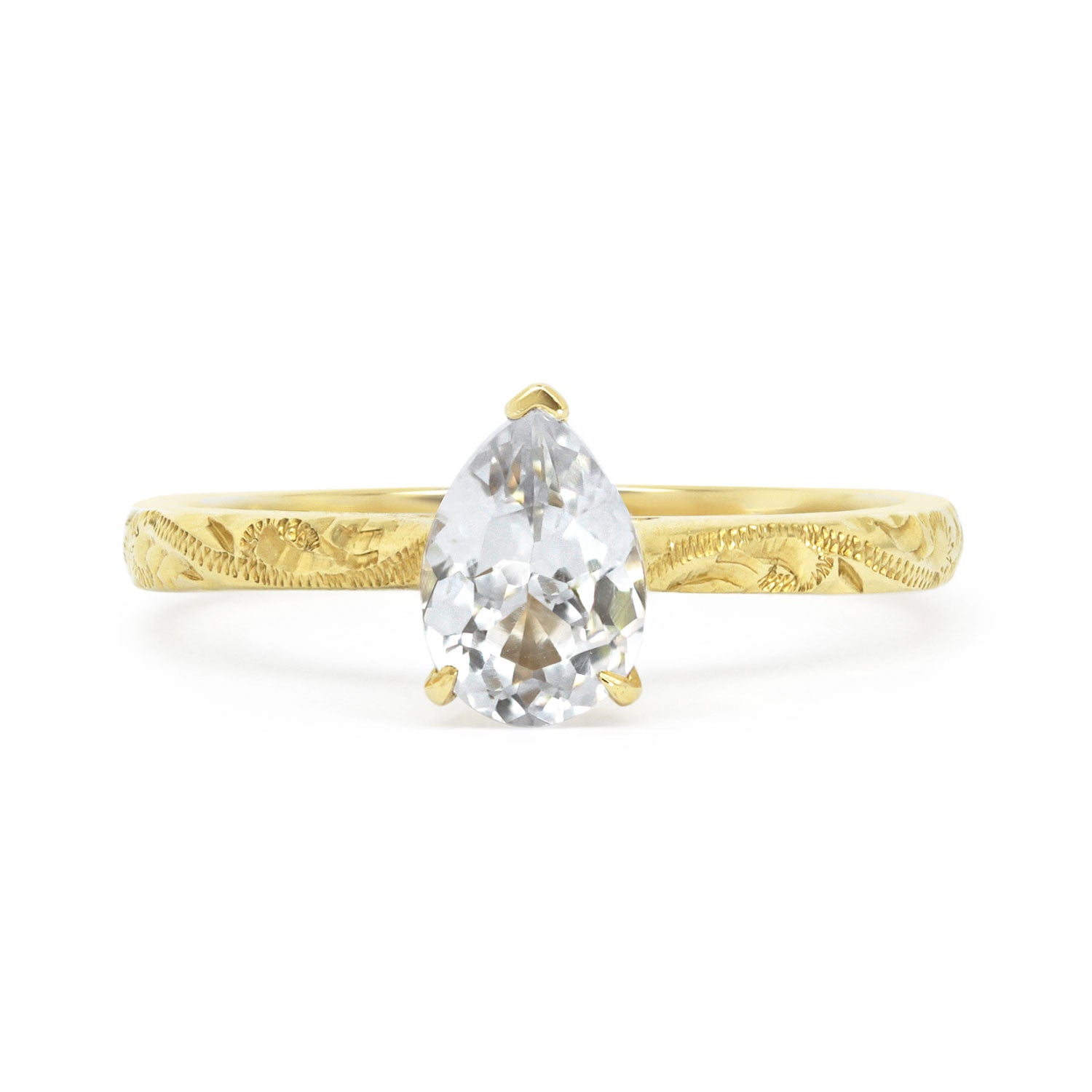 Fancy Athena ethical solitaire engagement ring in 18ct yellow Fairtrade Gold, hand-engraved and set with a blue marquise sapphire of fair-traded and traceable Sri Lankan provenance