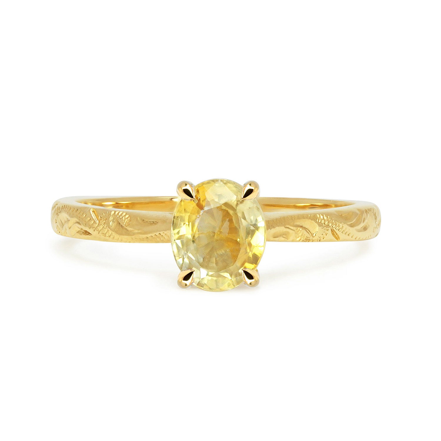 Fancy Athena ethical solitaire engagement ring in 18ct recycled yellow gold, hand-engraved and set with a yellow oval-cut sapphire of fair-traded and traceable Sri Lankan provenance