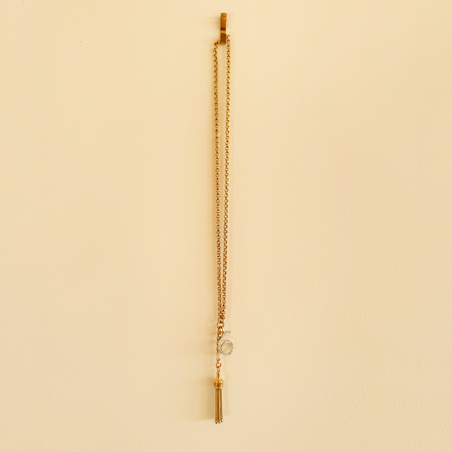 Reclaimed Vintage unique necklace with antique Victorian 9ct gold tassel pendant, 9ct recycled gold chain and a new numerology pendant crafted in recycled gold and conflict-free diamonds, secondary lifestyle view