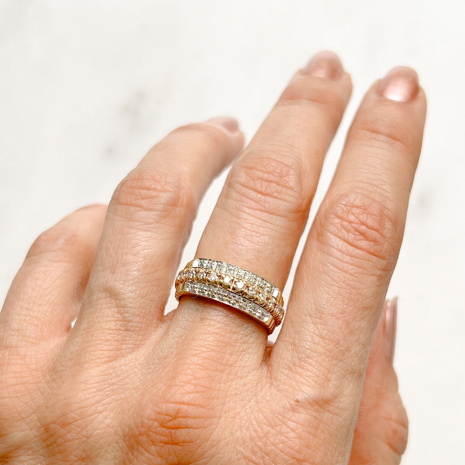 Reclaimed Vintage unique commitment ring, soldering together three antique Victorian half-diamond eternity rings in 9ct yellow and rose gold, on hand 2