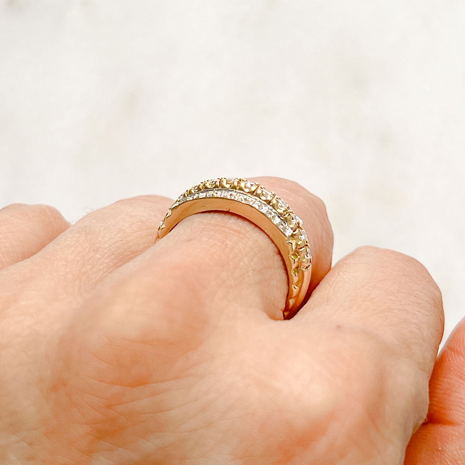 Reclaimed Vintage unique commitment ring, soldering together three antique Victorian half-diamond eternity rings in 9ct yellow and rose gold, on hand 3