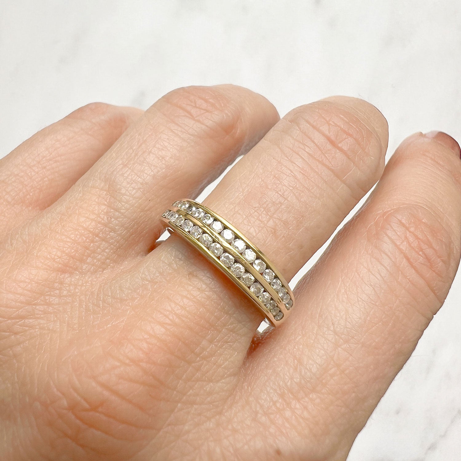 Reclaimed Vintage commitment ring with two antique Victorian half diamond eternity rings, on hand