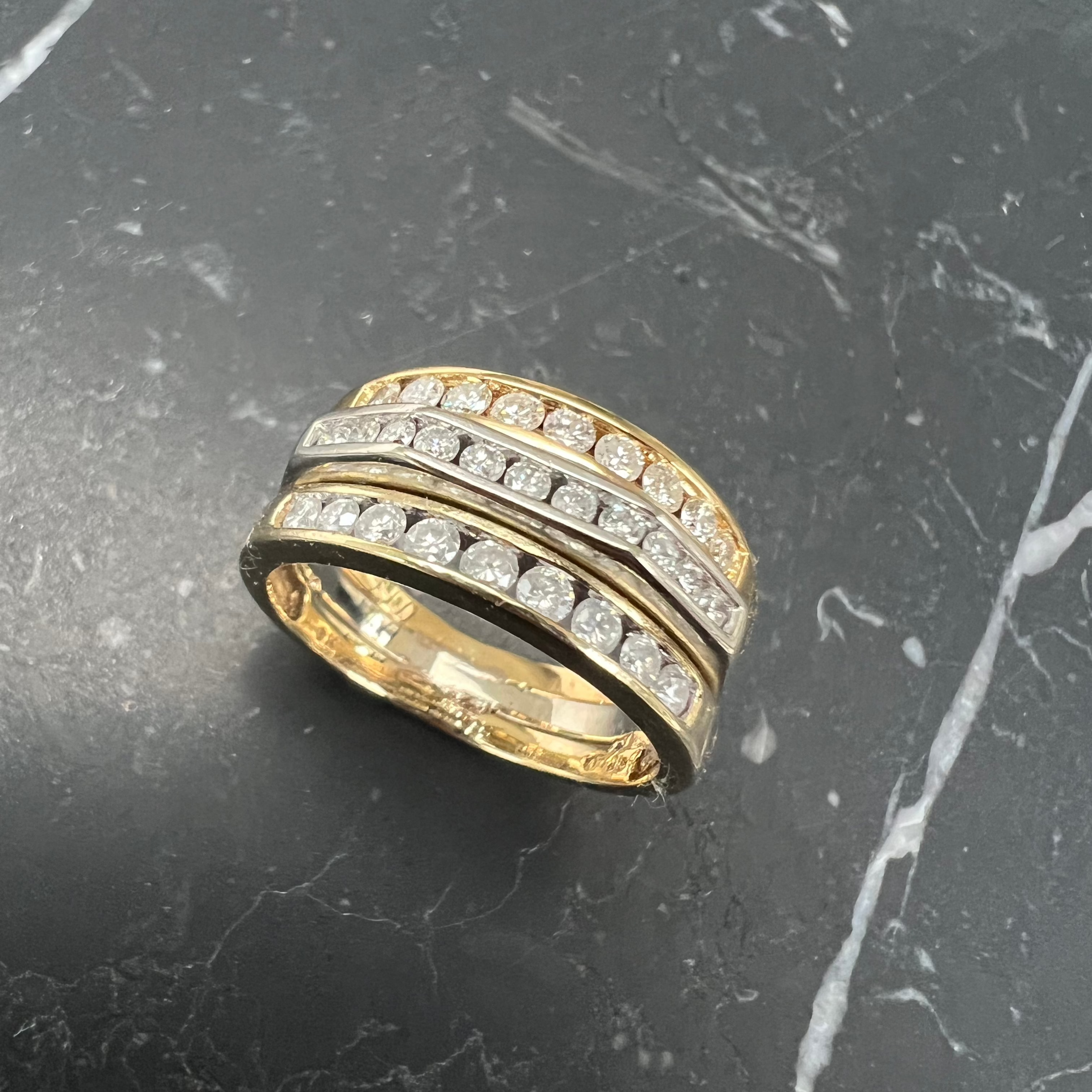 A unique commitment ring, made by soldering together three antique Victorian gold and old-cut diamond channel-set eternity rings, reclaimed and repurposed, lifestyle