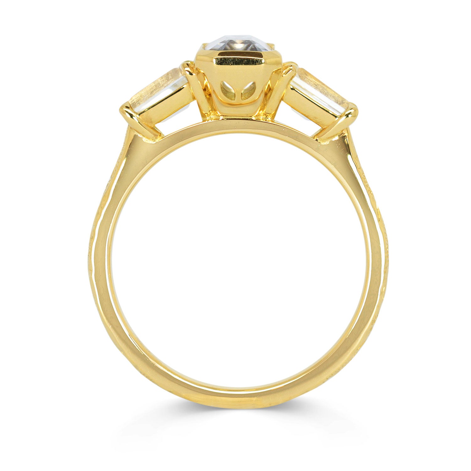 Lebrusan Studio Fancy Athena trilogy engagement ring with hand-engraved 18ct yellow Fairmined Eco Gold band and three emerald cut grey sapphires of ethical traceable origin, side view