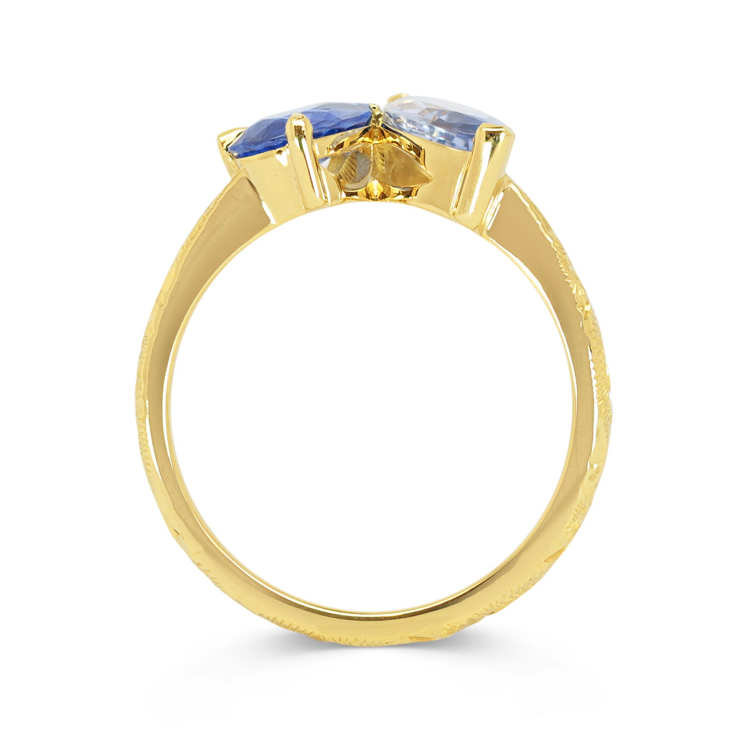 Lebrusan Studio Fancy Athena toi et moi engagement ring with hand-engraved 18ct yellow Fairmined Eco Gold band, a pear-cut blue sapphire and a marquise blue sapphire of ethical traceable origin, side view