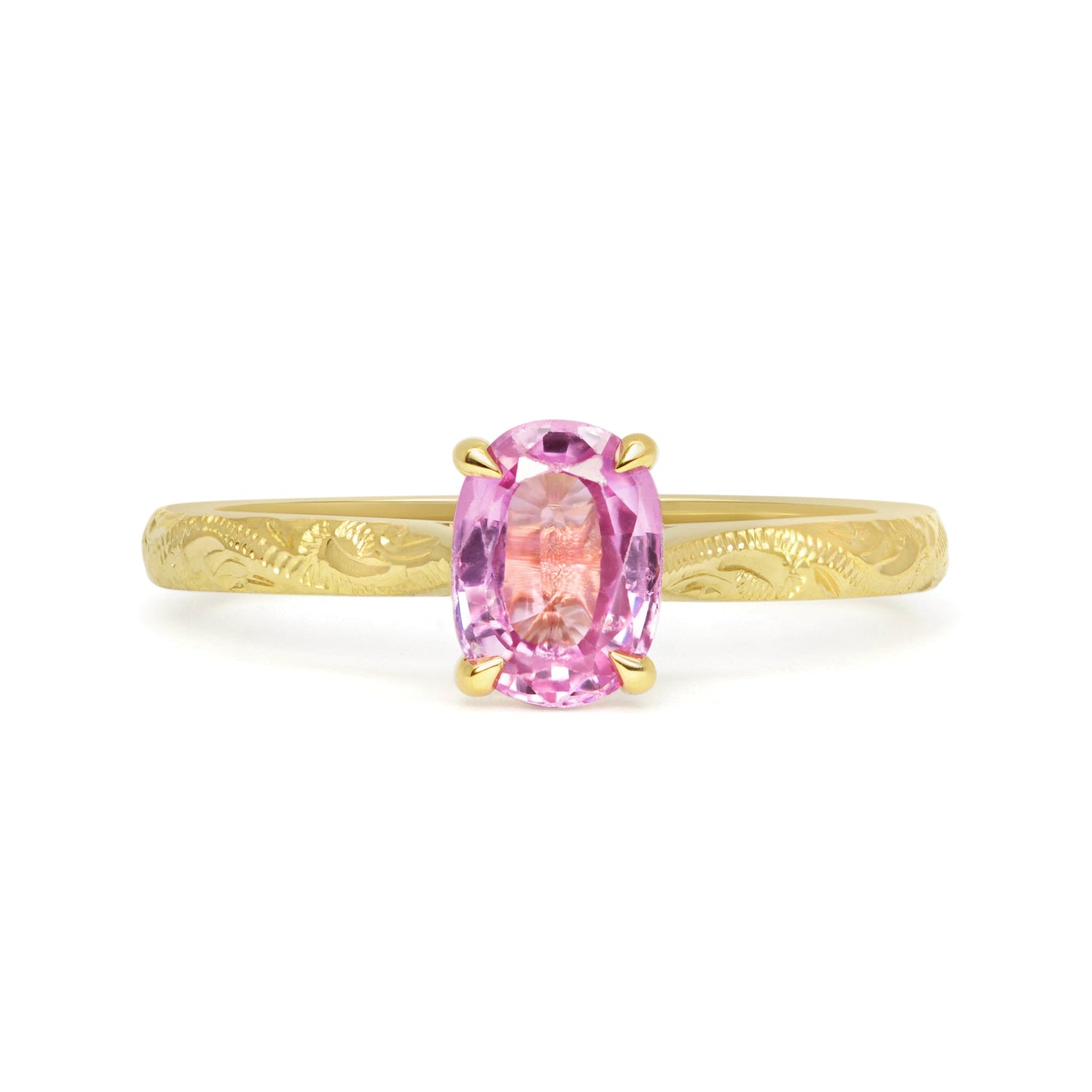 Solitaire engagement ring with a pink oval-cut fancy sapphire and an 18ct recycled eco gold band with hand engraving