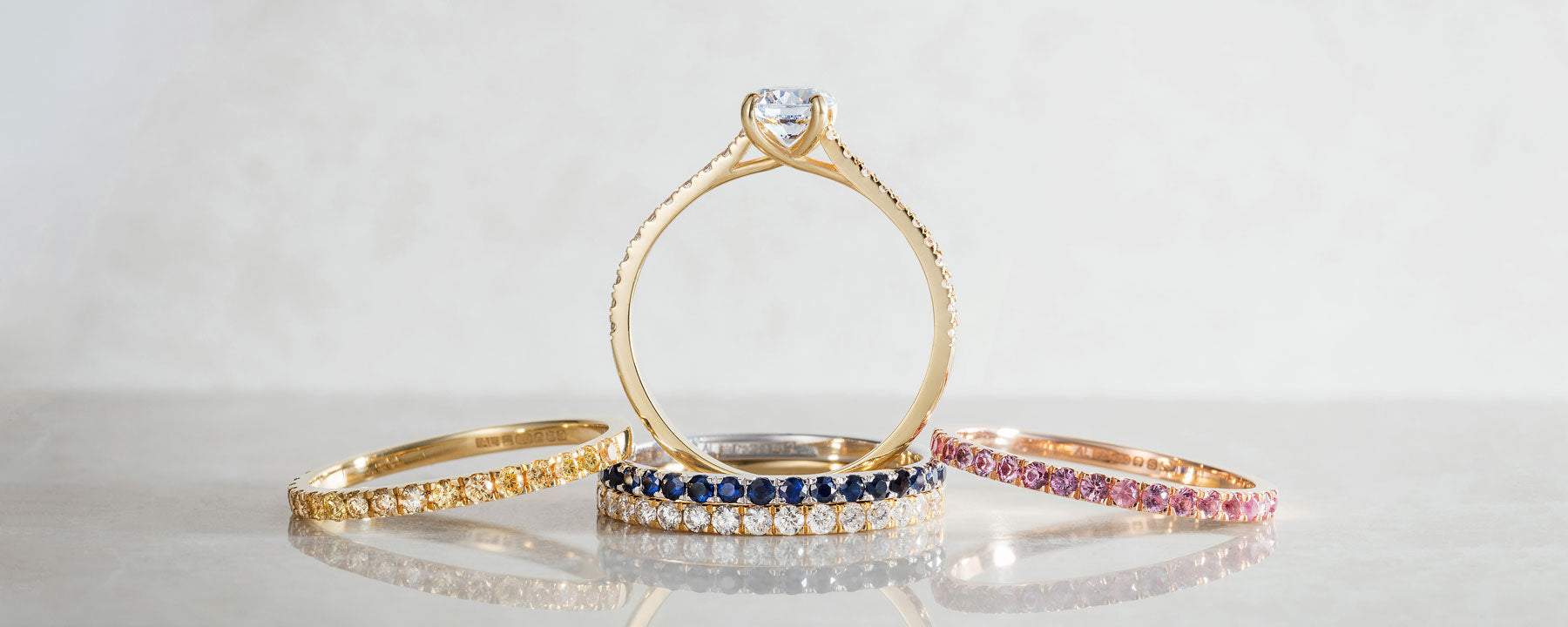 A selection of modern classic microset wedding bands and engagement rings from our sparkling Altair collection