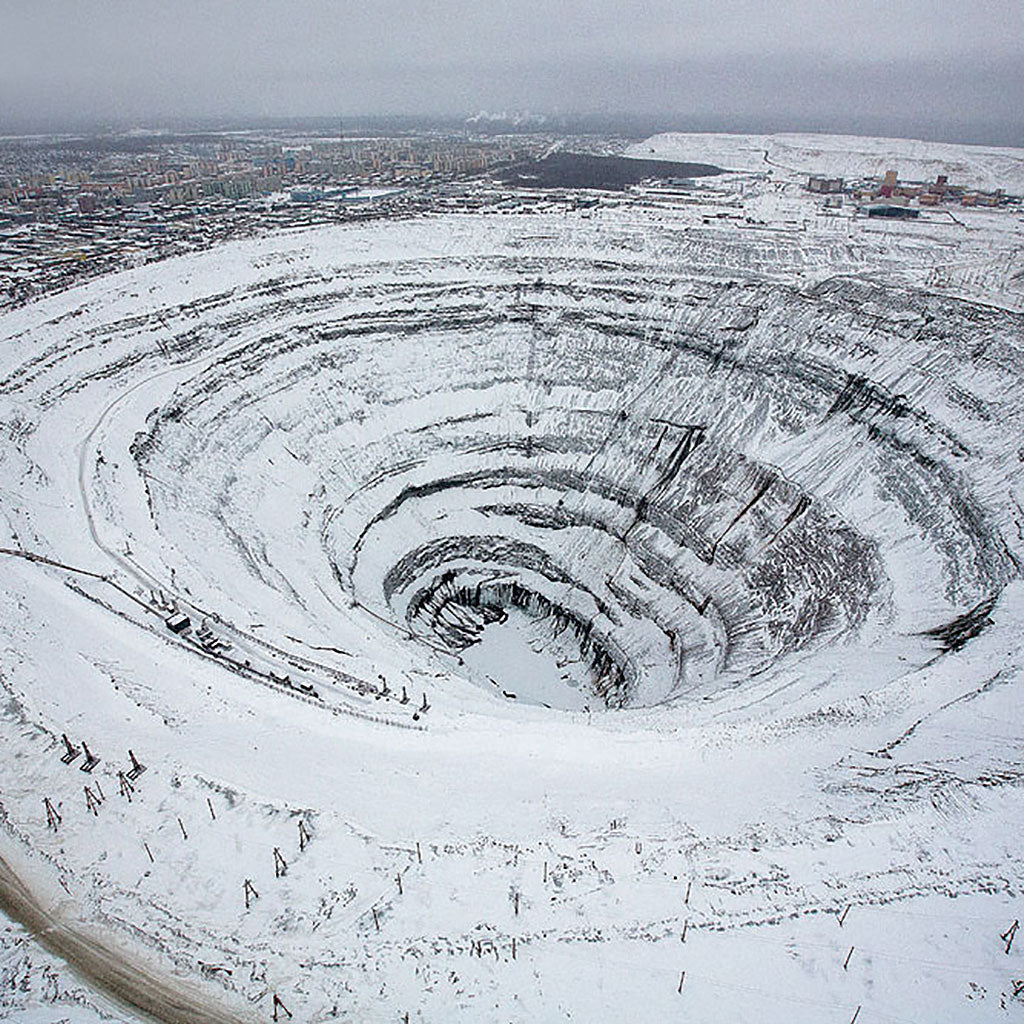 An open-pit diamond mine in Siberia in the snow. Lebrusan Studio is an ethical jeweller based in London, committed to finding the most ethical, environmentally sustainable and traceable diamond options for their bespoke jewellery