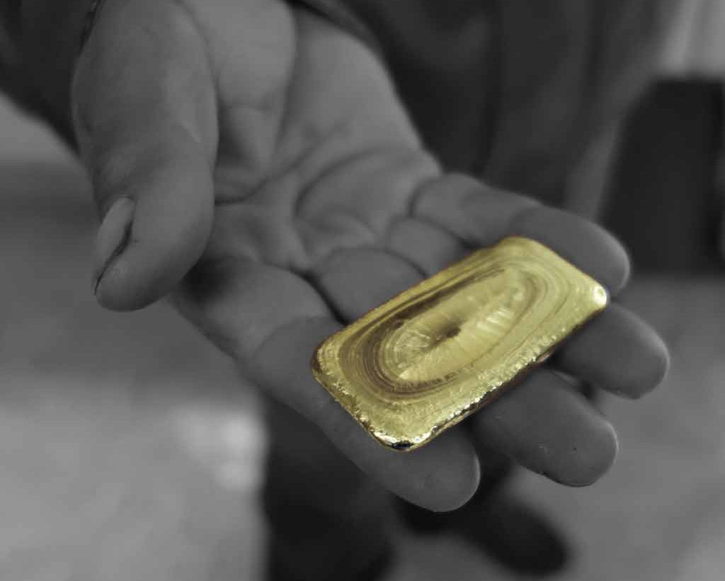 A Fairtrade Gold miner proudly showing off his gold