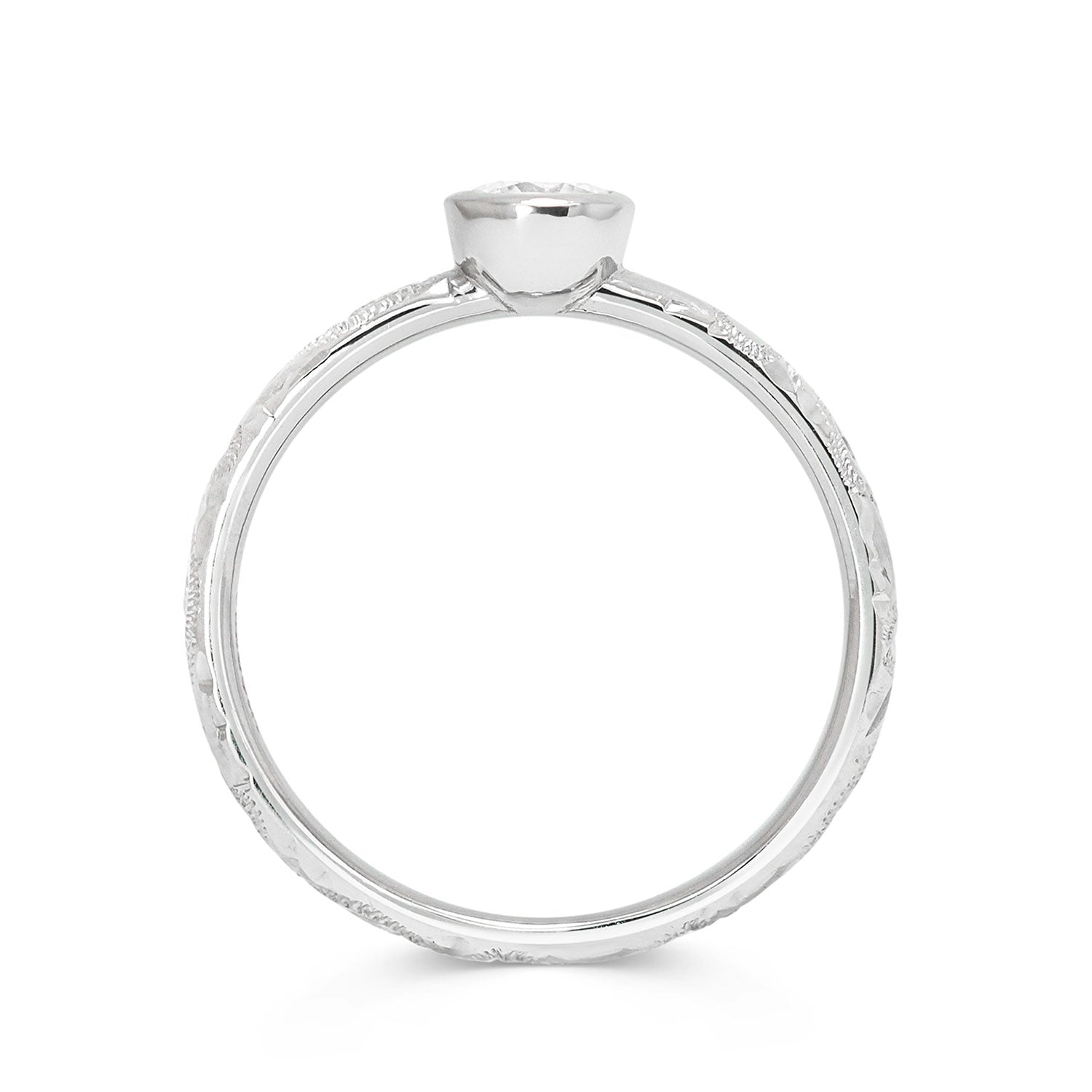 Solitaire 18ct white gold engagement ring with slim band hand-engraved with scrolls and a 0.33ct round brilliant-cut diamond in a rub-over setting, through view
