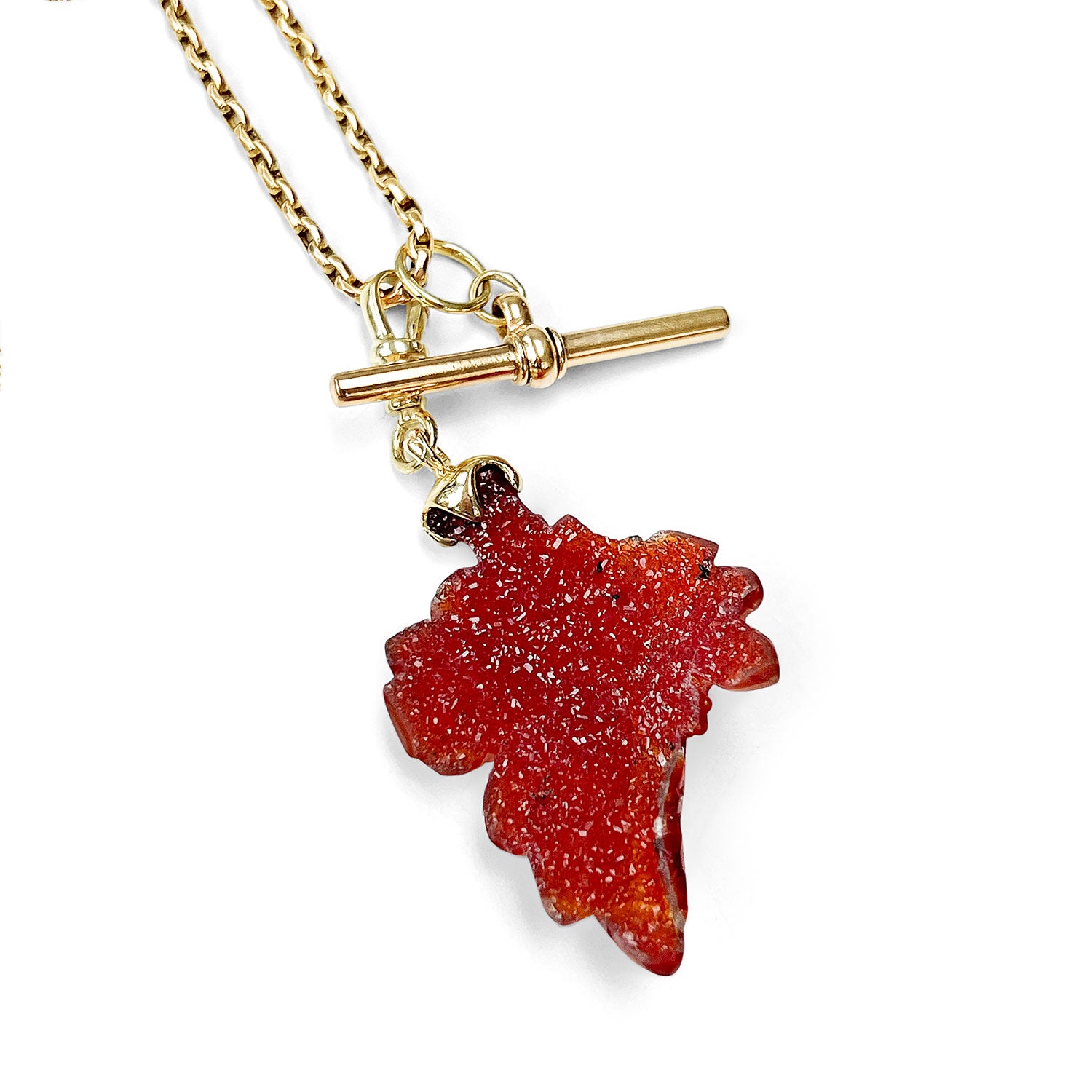 Reclaimed Vintage necklace with a red leaf-shaped carnelian quartz pendant, reclaimed antique Victorian gold chain and T-bar clasp on a white background