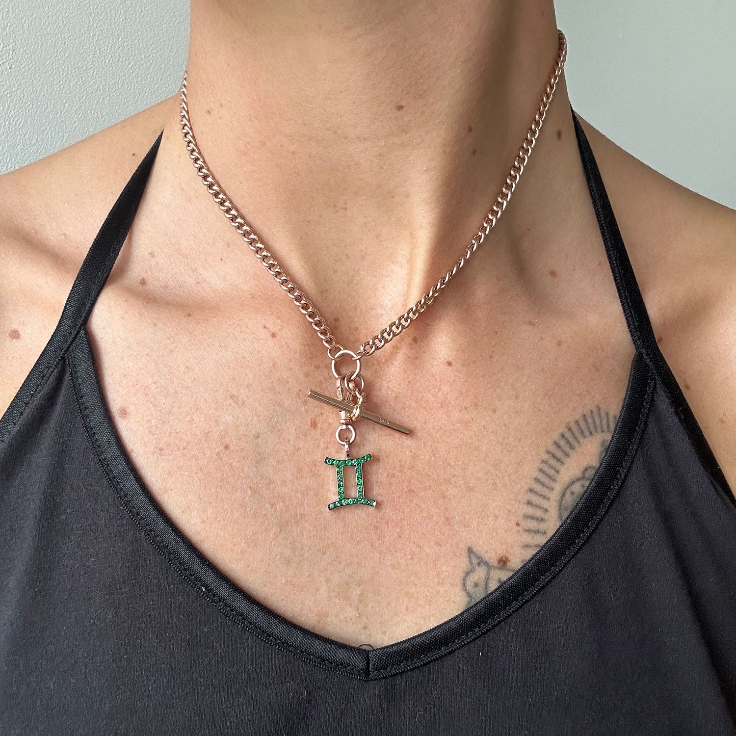Rose gold reclaimed antique Victorian chain necklace necklace with an ethical green emerald Gemini pendant, modelled on body 2