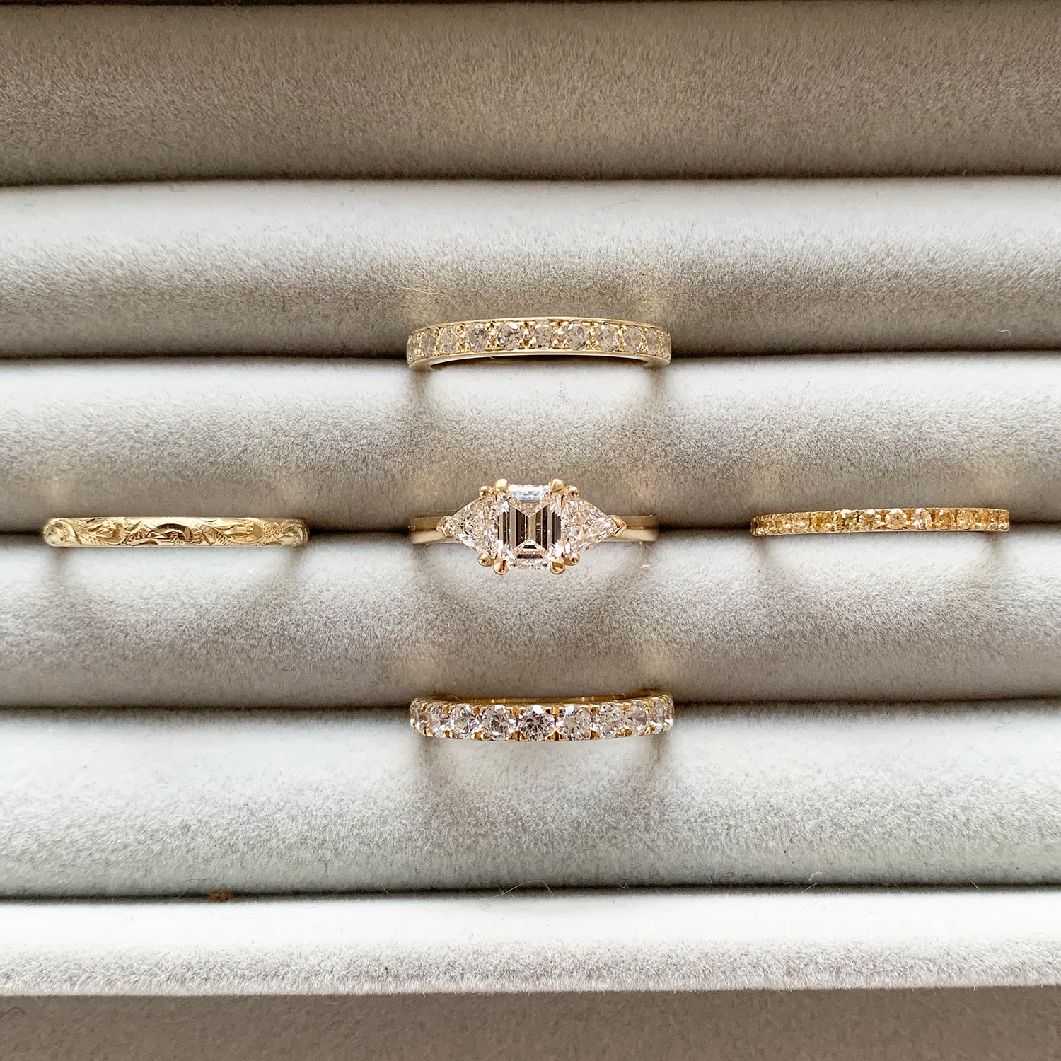 Bespoke Steve trilogy engagement ring, 18ct yellow Fairmined Ecological Gold, 0.7ct Canadamark emerald-cut diamond and trillion-cut artisanal Ocean Diamonds lifestyle