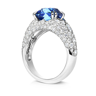 Bespoke bombe cocktail ring cast in environmentally sustainable recycled platinum and set with a cushion-cut fair-traded blue sapphire and conflict-free diamonds, side view
