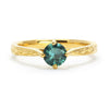 Bespoke Ed nature-inspired solitaire engagement ring, 18ct recycled yellow gold, hand-engraved fines and a traceable teal sapphire from Montana
