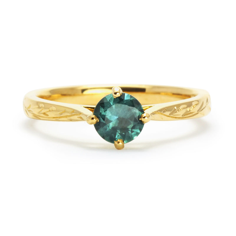 Bespoke Ed nature-inspired solitaire engagement ring, 18ct recycled yellow gold, hand-engraved fines and a traceable teal sapphire from Montana side