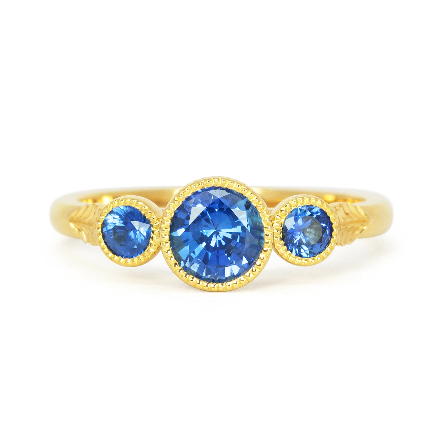 Bespoke ethical sapphire trilogy engagement ring, 18ct recycled yellow gold and traceable Sri Lankan sapphires