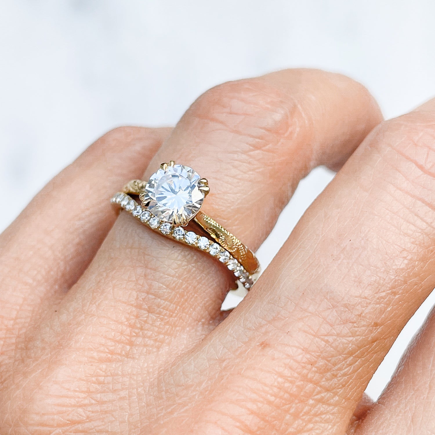 Lebrusan Studio Artisan Ethical Diamond Solitaire Engagement Ring, 1ct Ocean Diamond, 18ct Fairmined Ecological Gold, on the hand alongside the shaped microset Accademia Ethical Diamond Wedding Band 2