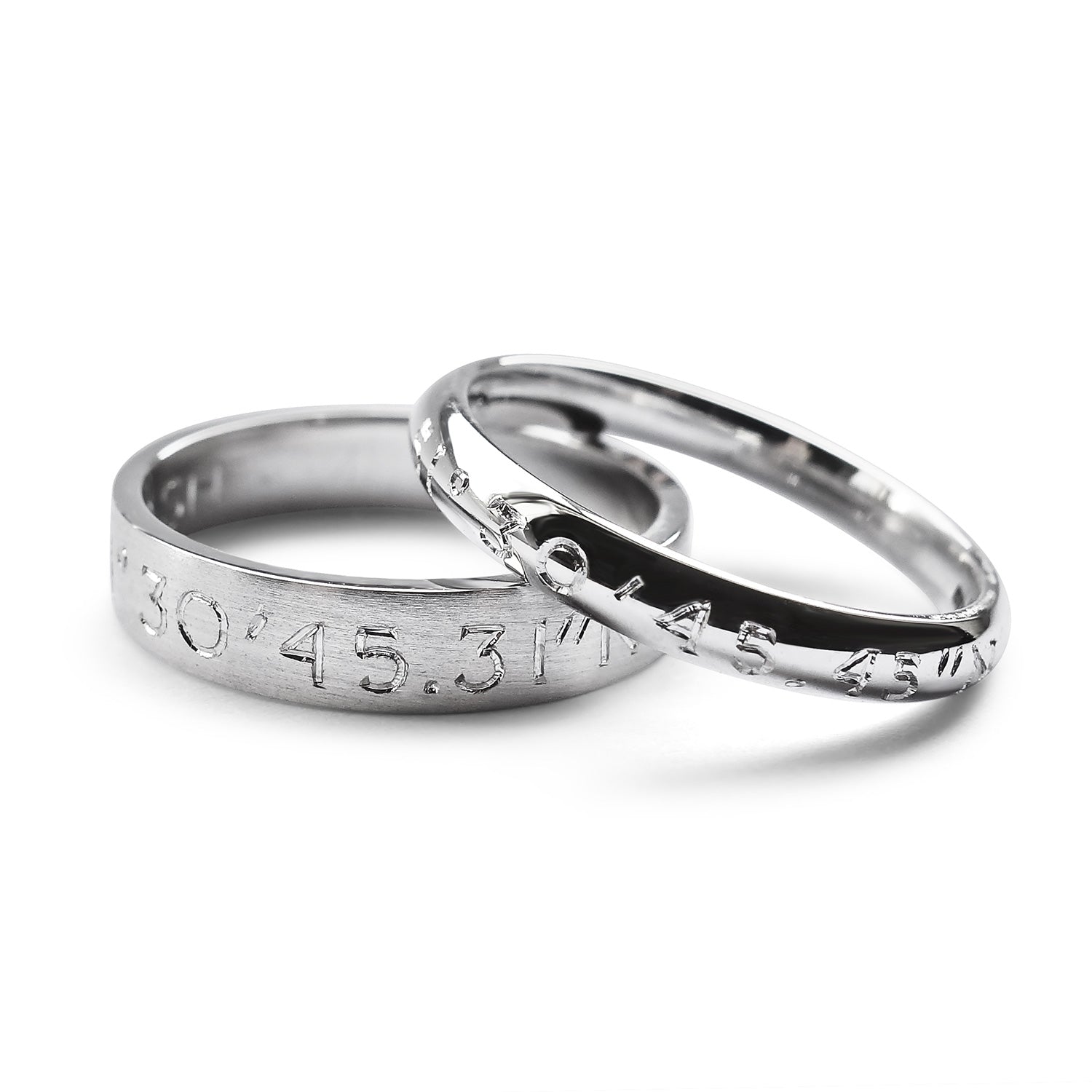 100% recycled platinum commitment rings, laser-inscribed with geographical coordinates. Engraved wedding bands for him and her
