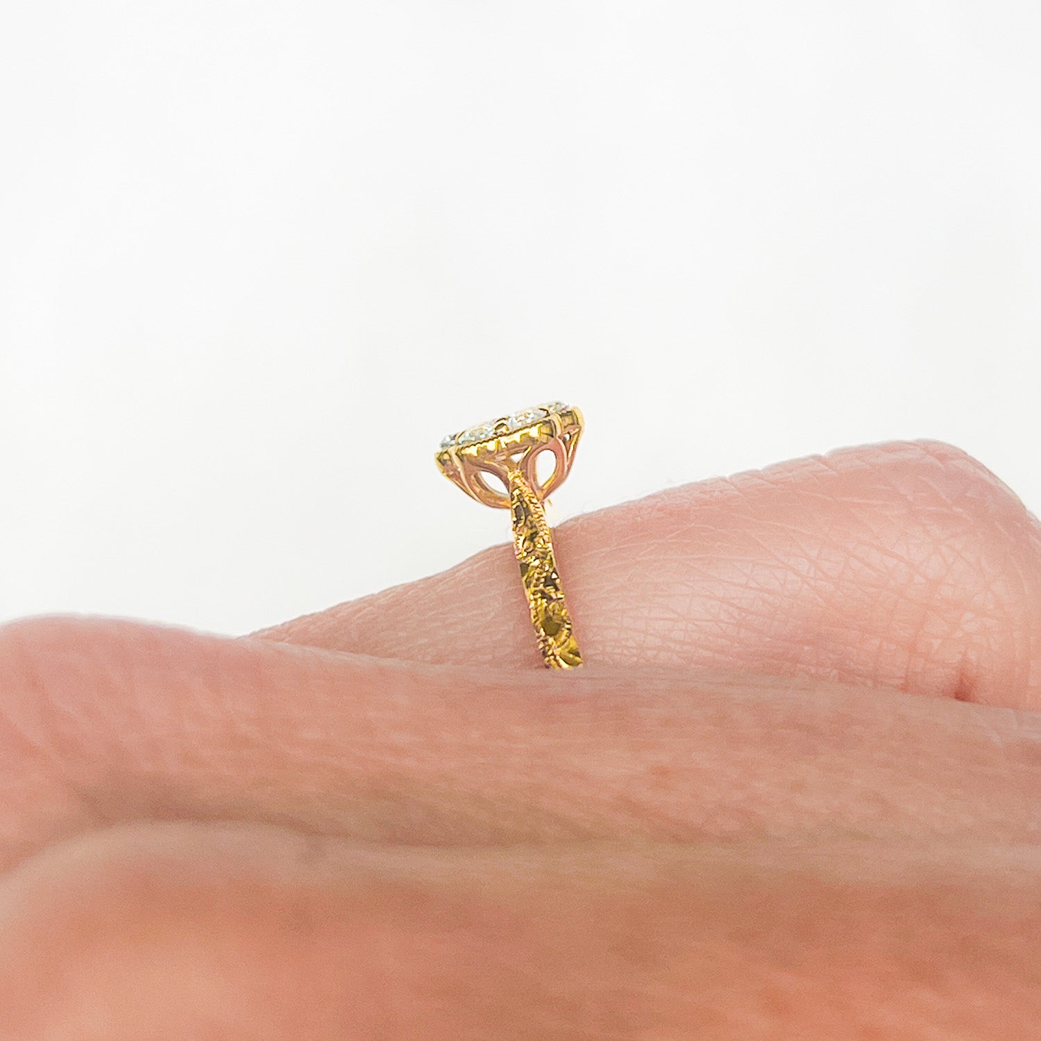 Daisy Ethical Diamond Cluster Engagement Ring, hand engraved, with traceable and conflict-free Canadian diamonds and 100% recycled yellow gold, view of daisy setting on hand