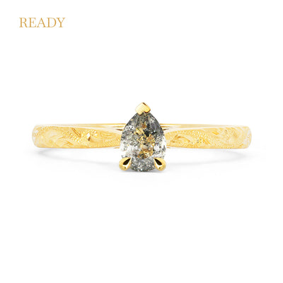 Fancy Athena ethical solitaire engagement ring in 18ct recycled yellow gold, hand-engraved and set with a pear-cut salt and pepper diamond of traceable and conflict-free Canadian provenance
