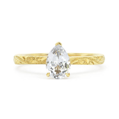 Fancy Athena ethical solitaire engagement ring in 18ct yellow Fairtrade Gold, hand-engraved and set with a blue marquise sapphire of fair-traded and traceable Sri Lankan provenance