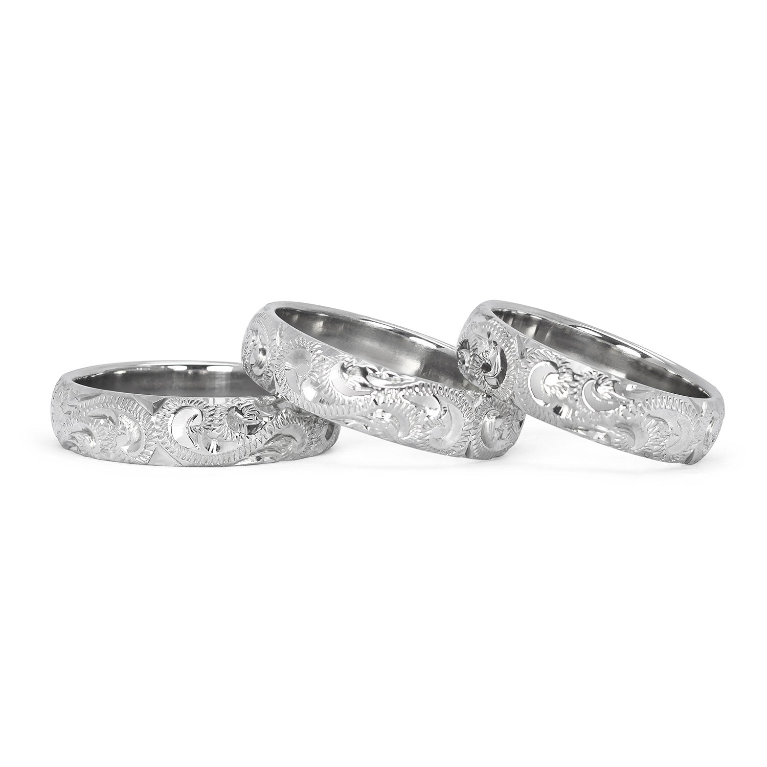 A trio of hand-engraved friendship rings, cast in 9ct recycled white gold, remodelled from our clients' late mother's ring 2