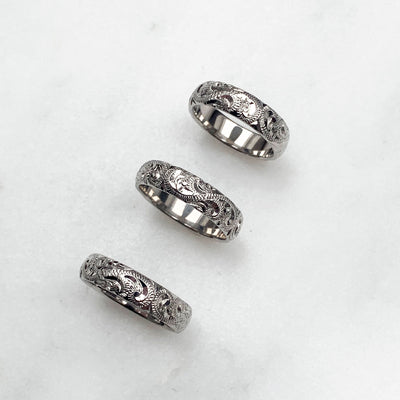 A trio of hand-engraved friendship rings, cast in 9ct recycled white gold, remodelled from our clients' late mother's ring 3