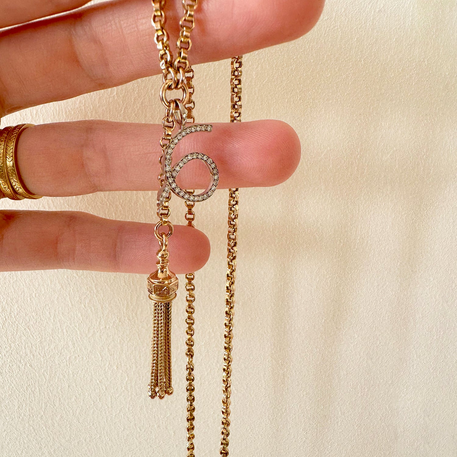 Reclaimed Vintage unique necklace with antique Victorian 9ct gold tassel pendant, 9ct recycled gold chain and a new numerology pendant crafted in recycled gold and conflict-free diamonds, lifestyle