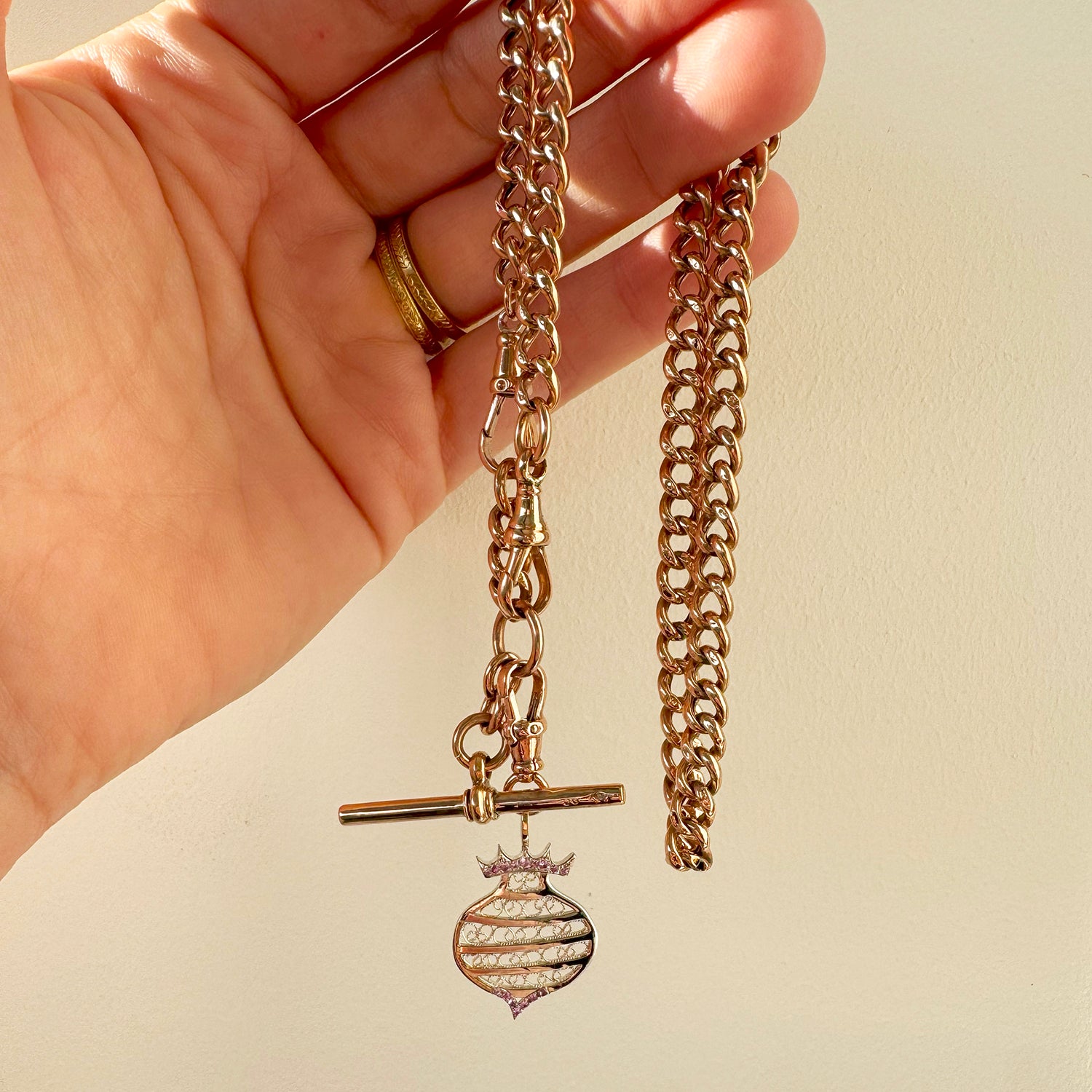 Unique necklace crafted using sustainable recycled rose gold, a repurposed antique Victorian T-bar clasp and a one-off hand-crafted filigree charm depicting a beehive, lifestyle