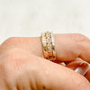 Three antique 9ct gold Victorian eternity rings half-set with diamonds, soldered together into a chunky stack, side view to show contrasting setting styles, on hand
