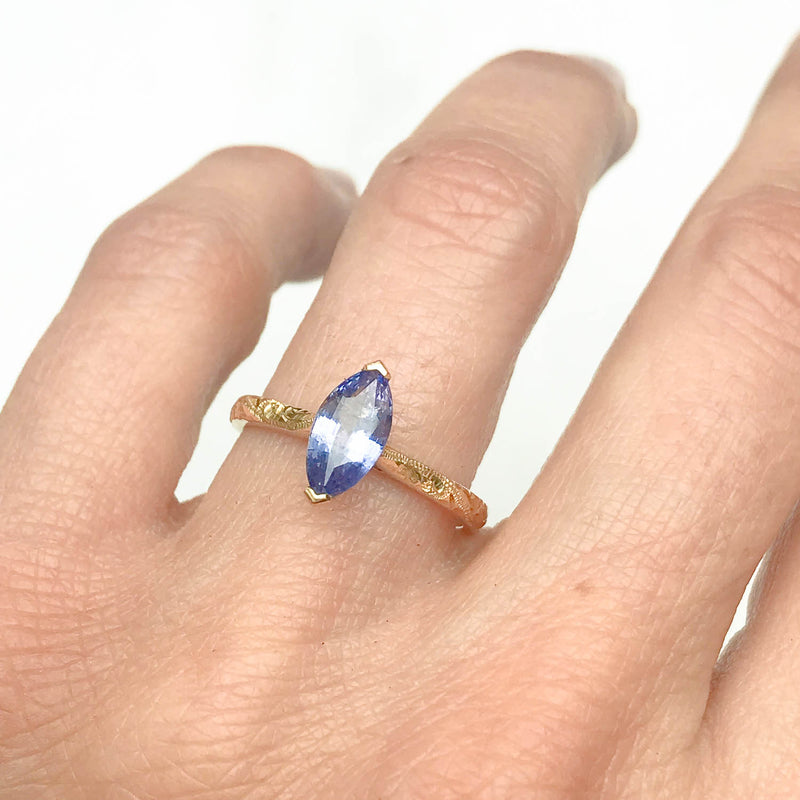 Fancy Athena ethical solitaire engagement ring in 18ct yellow Fairtrade Gold, hand-engraved and set with a blue marquise sapphire of fair-traded and traceable Sri Lankan provenance