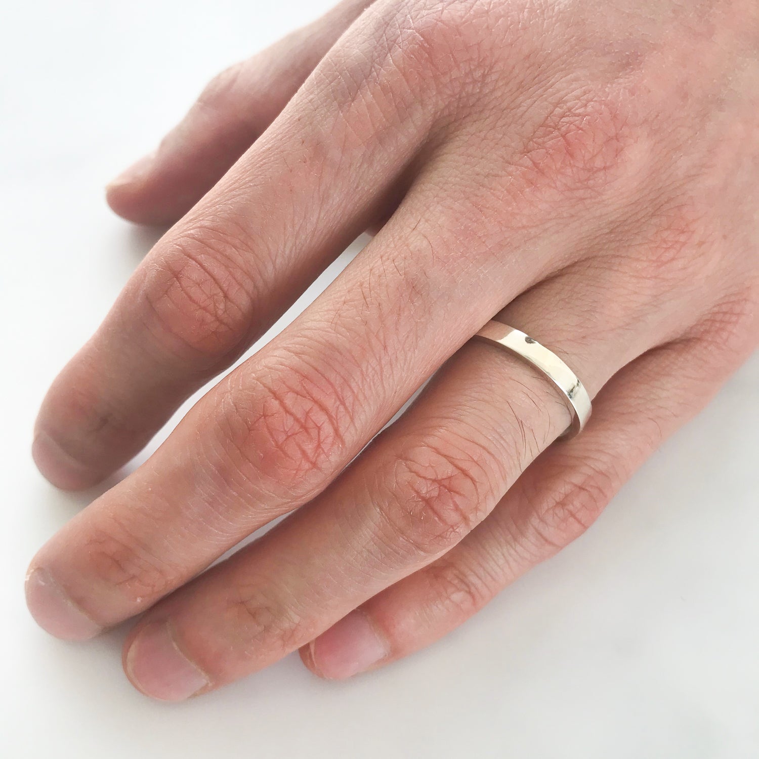 A slim platinum men's wedding band