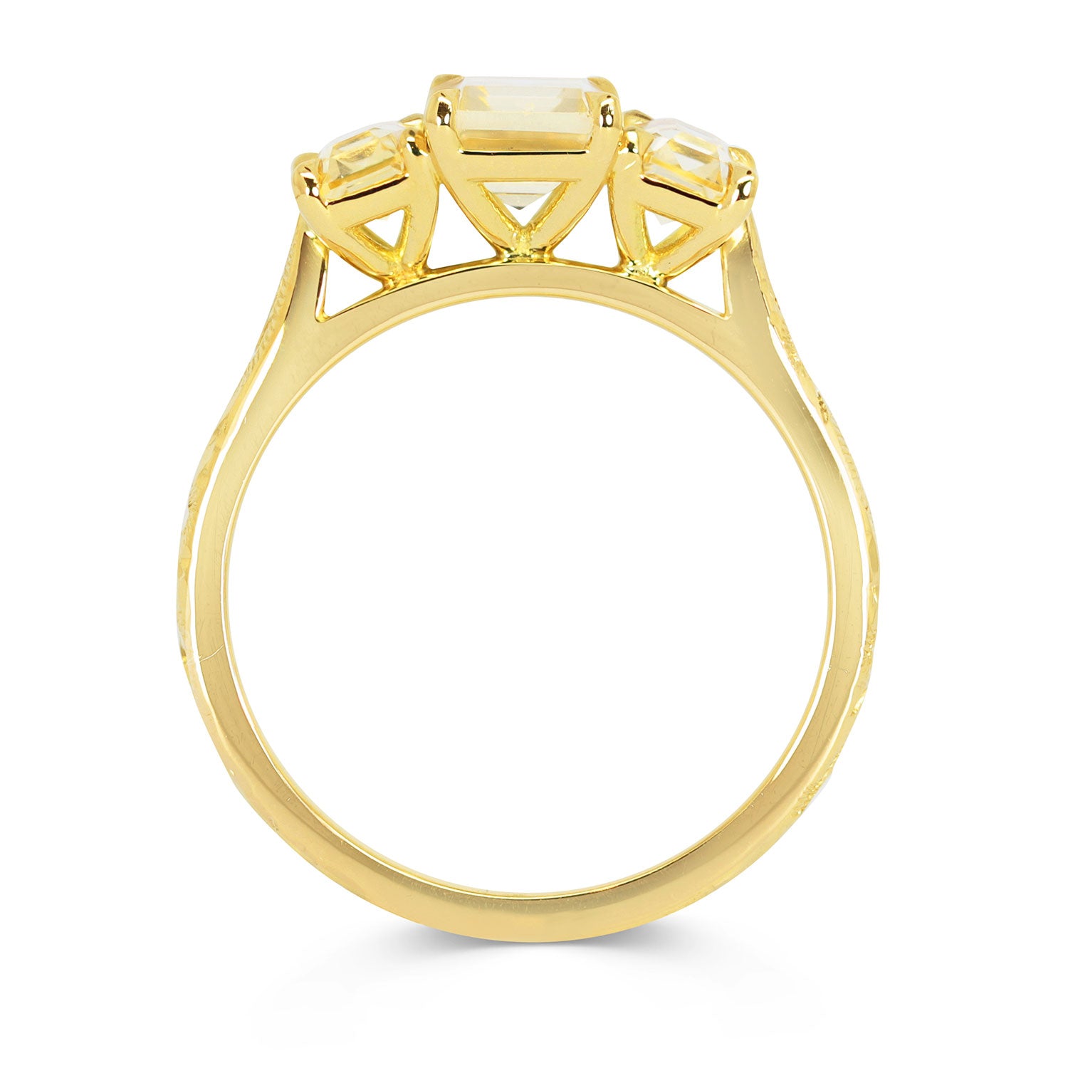 Lebrusan Studio Fancy Athena trilogy engagement ring with hand-engraved 18ct yellow Fairmined Eco Gold band and three emerald cut yellow sapphires of ethical traceable origin, side view
