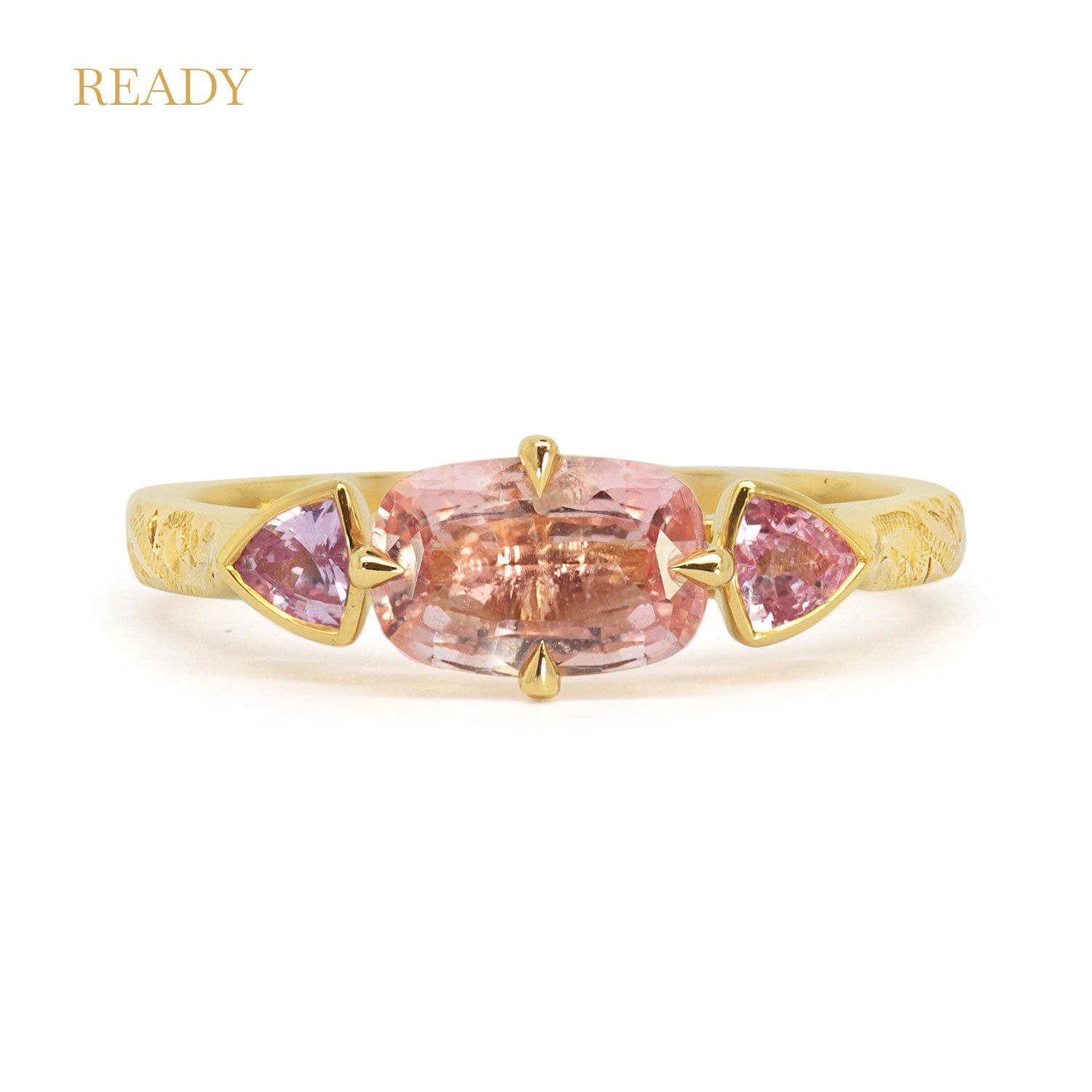 Lebrusan Studio Fancy Athena trilogy engagement ring with hand-engraved 18ct Fairmined Eco Gold, a cushion-cut pink sapphire and two trillion-cut pink sapphires