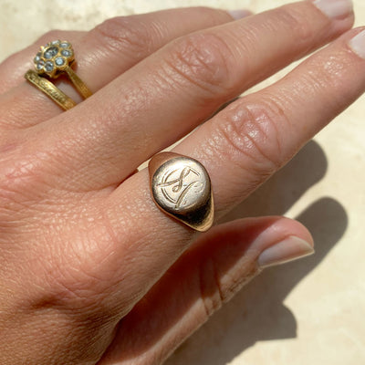 An old family signet ring, hand-engraved with an 'M', cast in 9ct rose gold and very worn over time. This ring was melted down and recycled as Mark's new wedding band