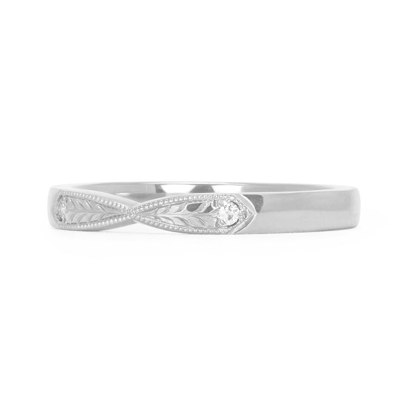 Lebrusan Studio's Amare Laurus pinched wedding band, hand-engraved with a symmetrical laurel motif and milgrain beading, and set with two conflict-free Canadian diamonds