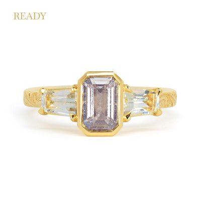 Lebrusan Studio Fancy Athena trilogy engagement ring with hand-engraved 18ct yellow Fairmined Eco Gold band and three emerald cut grey sapphires of ethical traceable origin