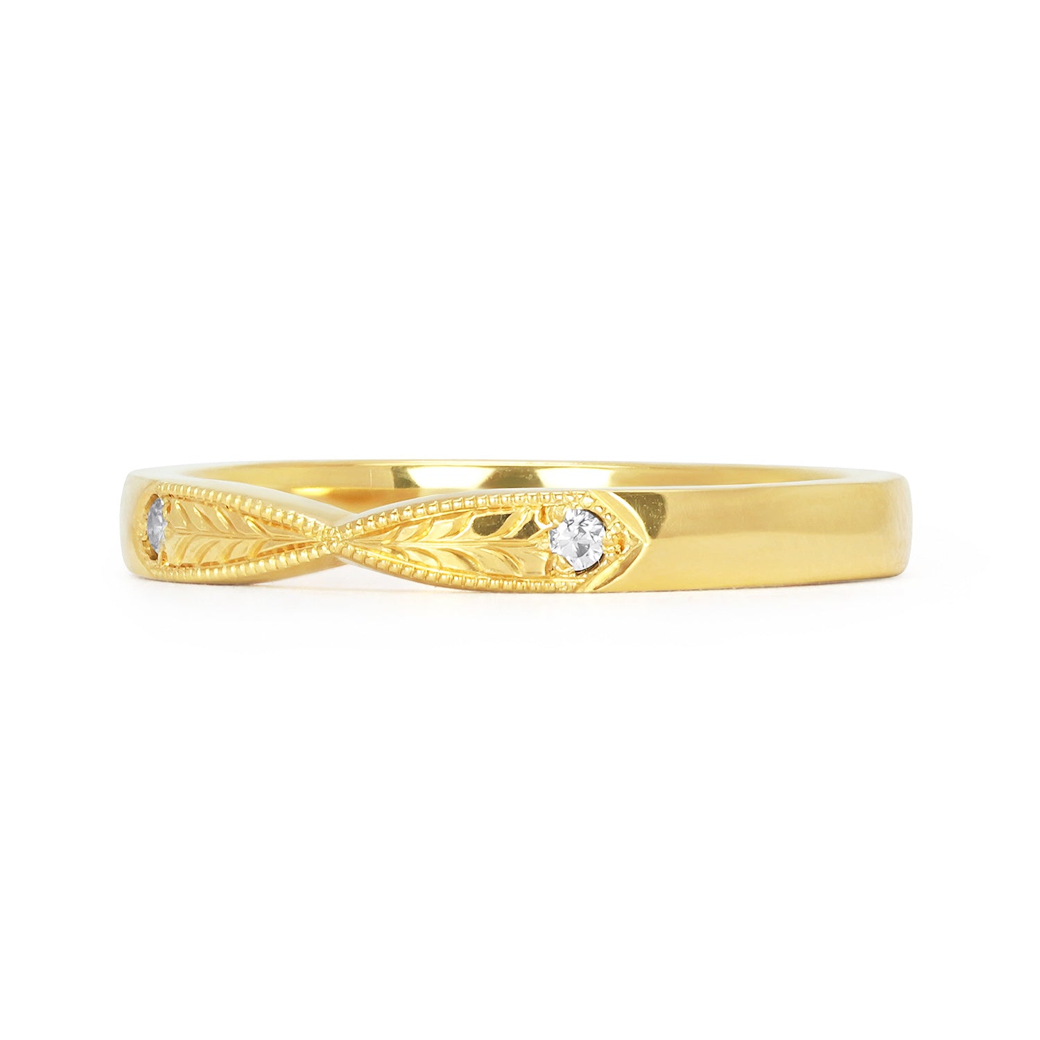 Lebrusan Studio's Amare Laurus ethical wedding ring with a pinched shape, hand engraved laurel wreath motif and milgrain beading, and two conflict-free diamonds, side view