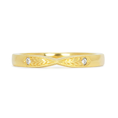 Lebrusan Studio's Amare Laurus ethical wedding ring with a pinched shape, hand engraved laurel wreath motif and milgrain beading, and two conflict-free diamonds