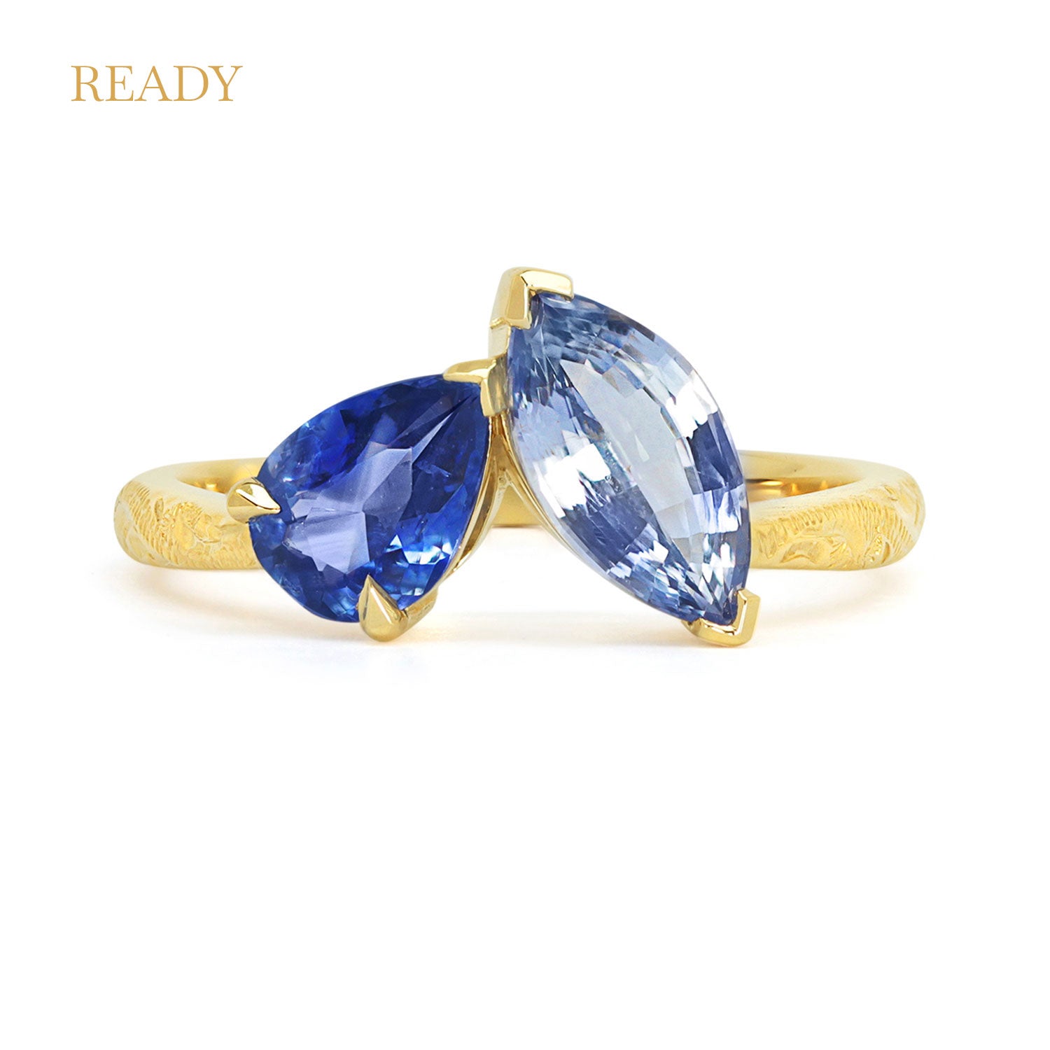 Lebrusan Studio Fancy Athena toi et moi engagement ring with hand-engraved 18ct yellow Fairmined Eco Gold band, a pear-cut blue sapphire and a marquise blue sapphire of ethical traceable origin