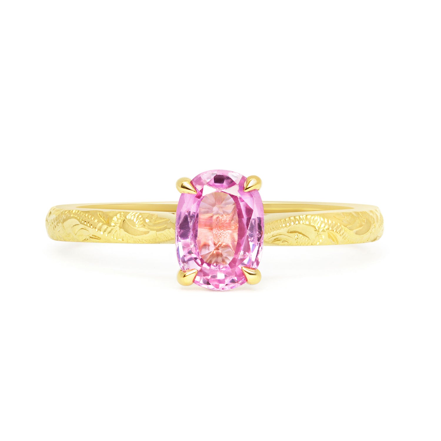Solitaire engagement ring with a pink oval-cut fancy sapphire and an 18ct recycled eco gold band with hand engraving
