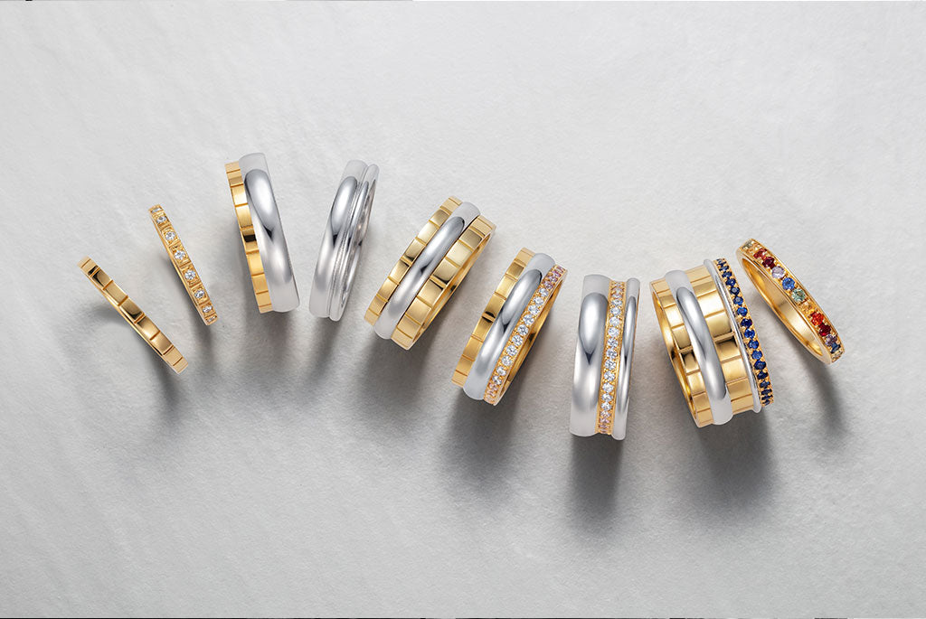 The Freedom Collection of unique eternity rings and commitment rings for LGBTQ+ couples. Designer wedding bands men and women, characterised by stackable components, recycled gold and fair-traded coloured sapphires