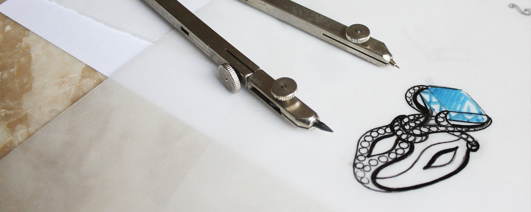 A bespoke cocktail ring design, hand-drawn onto tracing paper using fine black pen and blue ink to represent the blueness of an ethical sapphire