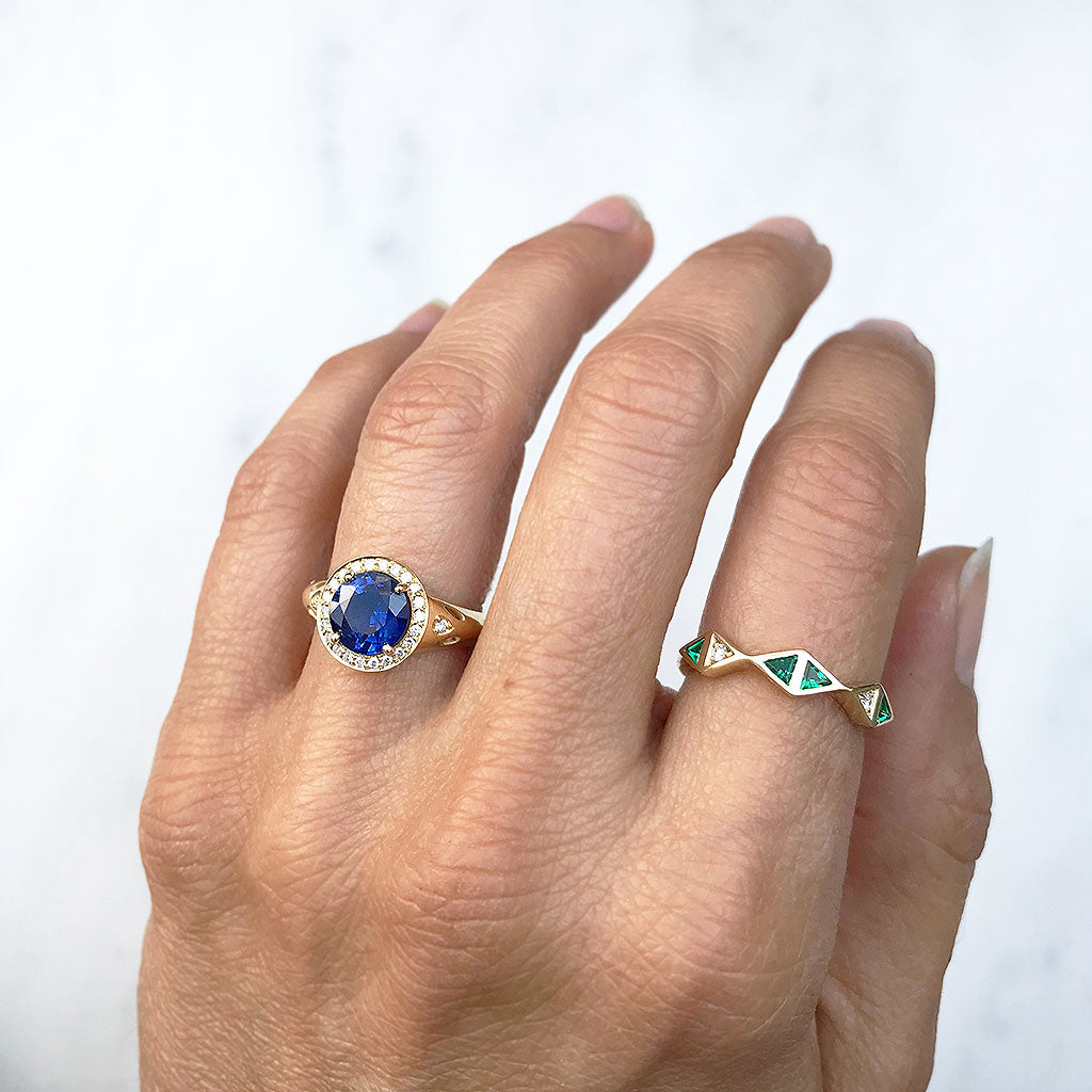 Bespoke sapphire halo engagement ring and trillion-cut emerald and diamond jacket ring, crafted using 18ct recycled gold and repurposed gemstones from our client's old engagement ring