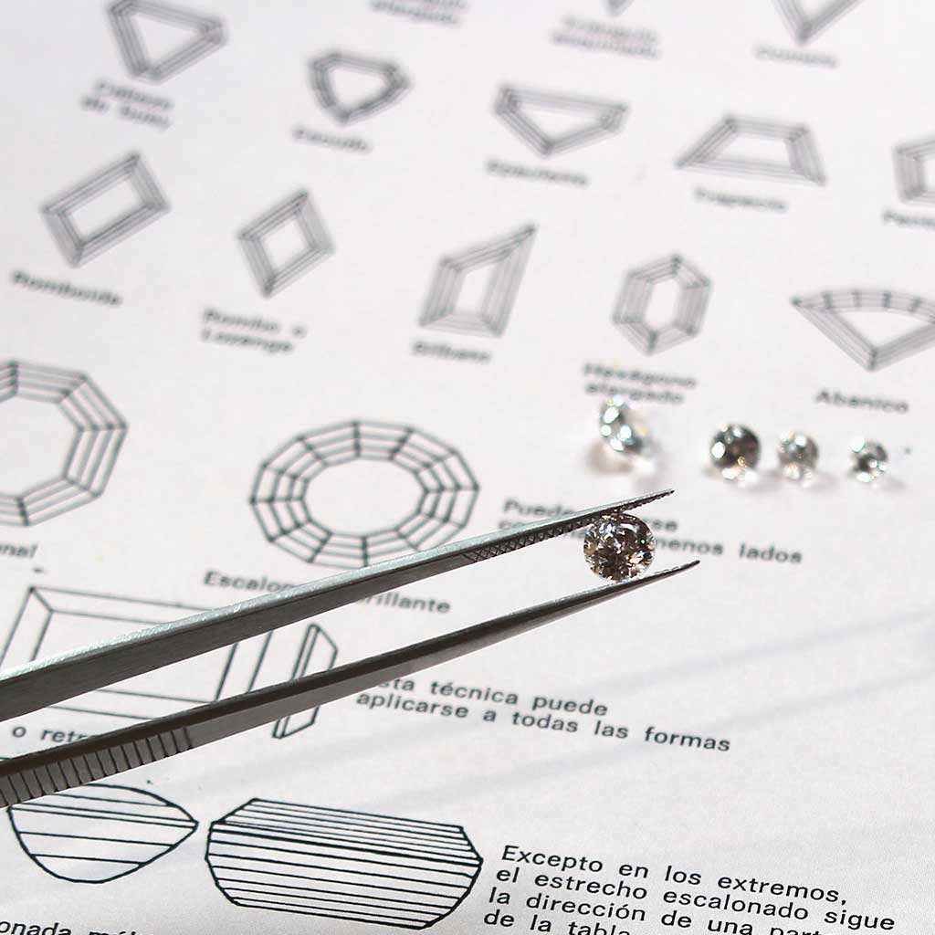 A brilliant-cut lab-grown diamond held aloft by diamond tweezers. Lebrusan Studio is a London-based ethical jeweller investigating whether lab-grown diamonds really are a more sustainable alternative