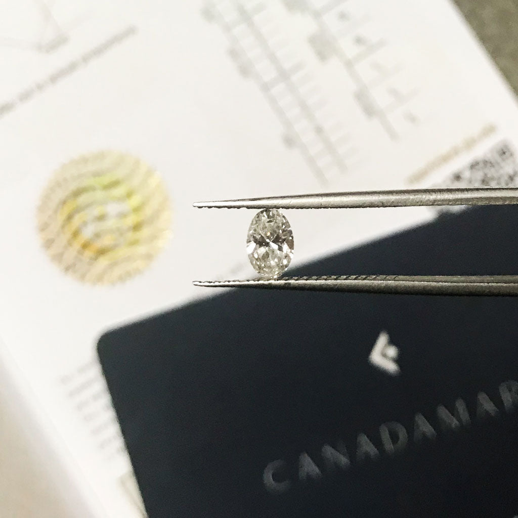 An oval-cut Canadian diamond with its unique Canadamark certification